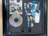 a framed photo of a cd and a cd in a black frame