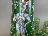 a green vase with a picture of a knight on it