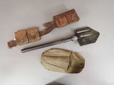 a shovel, a hat, and other items on a table