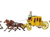 four figurines of people riding on horses and a horse drawn carriage
