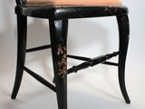 a black chair with a tan seat on a white background