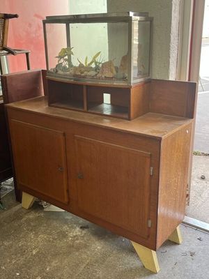 a wooden cabinet with a fish tank on top of it