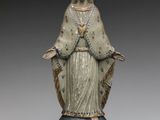 statue of the virgin of guadalupe, made of wood and painted in blue and white