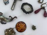a white table with a bunch of jewelry on it