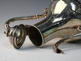 a silver vase that is sitting on a table
