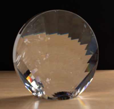 a crystal ball sitting on a table with a black background