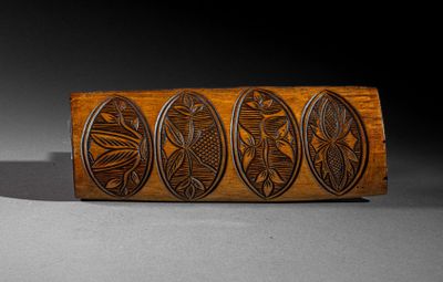 an image of a close up of a piece of wood with carvings on it