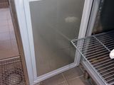 a small refrigerator with a door open in a kitchen