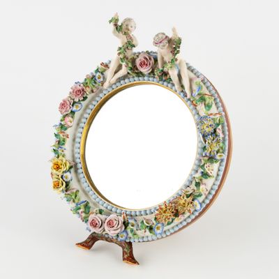 a picture of a mirror with flowers and birds on it