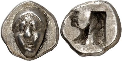 a close up of a coin with a face on it