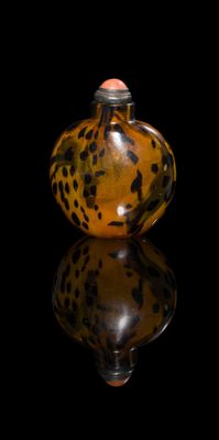 a glass bottle with a leopard print design on it