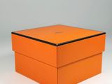 an orange box sitting on top of a white surface