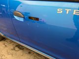 a close up of a blue car with a stencil on it