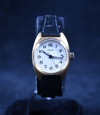 a close up of a watch on a black surface