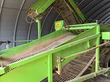 a green machine that is working in a building