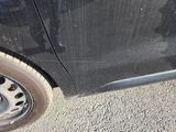 a black car that has a flat tire on it