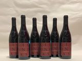 six bottles of wine are lined up in a row on a table