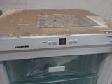 a white refrigerator with the door open in a kitchen