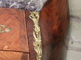 a marble top chest of drawers with a marble top