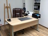 a desk and chair in a room with a book shelf