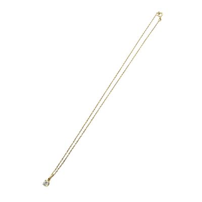 a gold necklace with a diamond on a white background