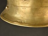 a gold helmet that is sitting on a table