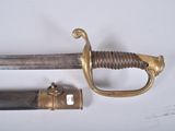 a sword that is laying on a table next to another sword