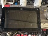 a tablet computer sitting on a workbench in a workshop