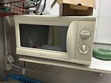 a microwave sitting on a counter in a small kitchen