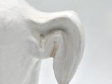 a close up of a white elephant statue on a white background