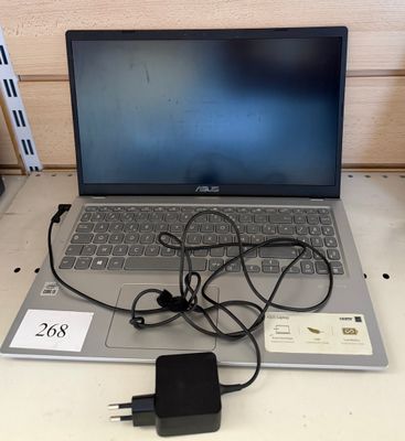 a laptop that is sitting on a table with a charger