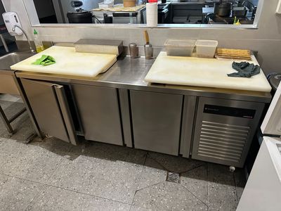 stainless steel counter top with two cutting boards on top of it