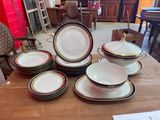 many plates and bowls sitting on a table in a room