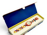 a box with a watch inside of it on a white surface
