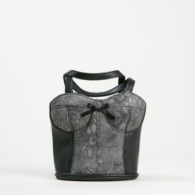 sac à main noir et blanc orné d'un nœud sur le devant