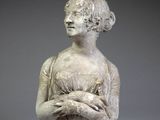 statue of a woman holding a bird in her hands