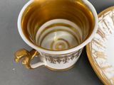 a cup and saucer sitting on a table