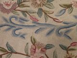 a close up of a rug with flowers on it