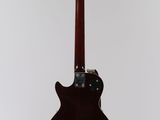 a close up of a guitar on a stand with a white background
