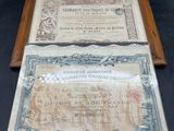an old certificate with a wooden frame on a black background