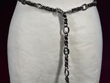 a white mannequin torso with a chain around it