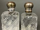 pair of antique cut glass perfume bottles with brass tops