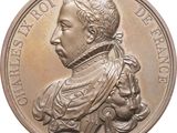 une image représentant une médaille de bronze sur laquelle figurent le portrait d'un homme et d'un chien