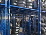 many tires stacked on a rack in a warehouse