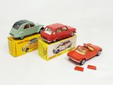three small toy cars sitting on top of a box