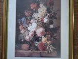framed picture of a vase of flowers on a table in a room