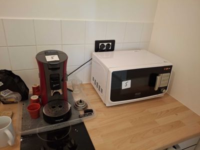 a microwave and a coffee maker on a kitchen counter