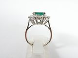 a close up of a ring with a green stone on top of it