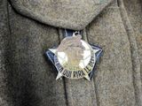 a badge on the lapel of a man ' s jacket