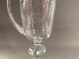 a glass pitcher sitting on top of a table